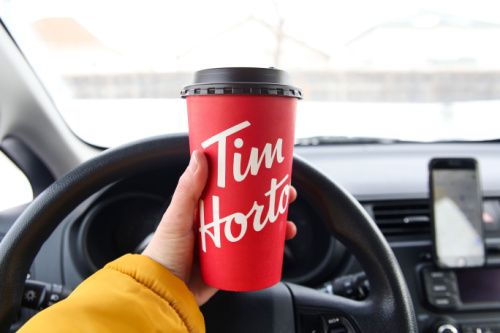 Winnipeg, Manitoba / Canada - February 17, 2020: Holding a Tim Hortons Large Cup of Coffee.